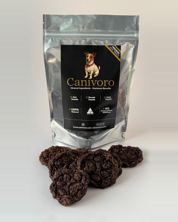 Canivoro Beef & Blueberry Bites pouch with a pile of paw-print stamped bites in front