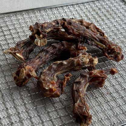 Slow-dried free-range chicken necks on a dehydrator rack