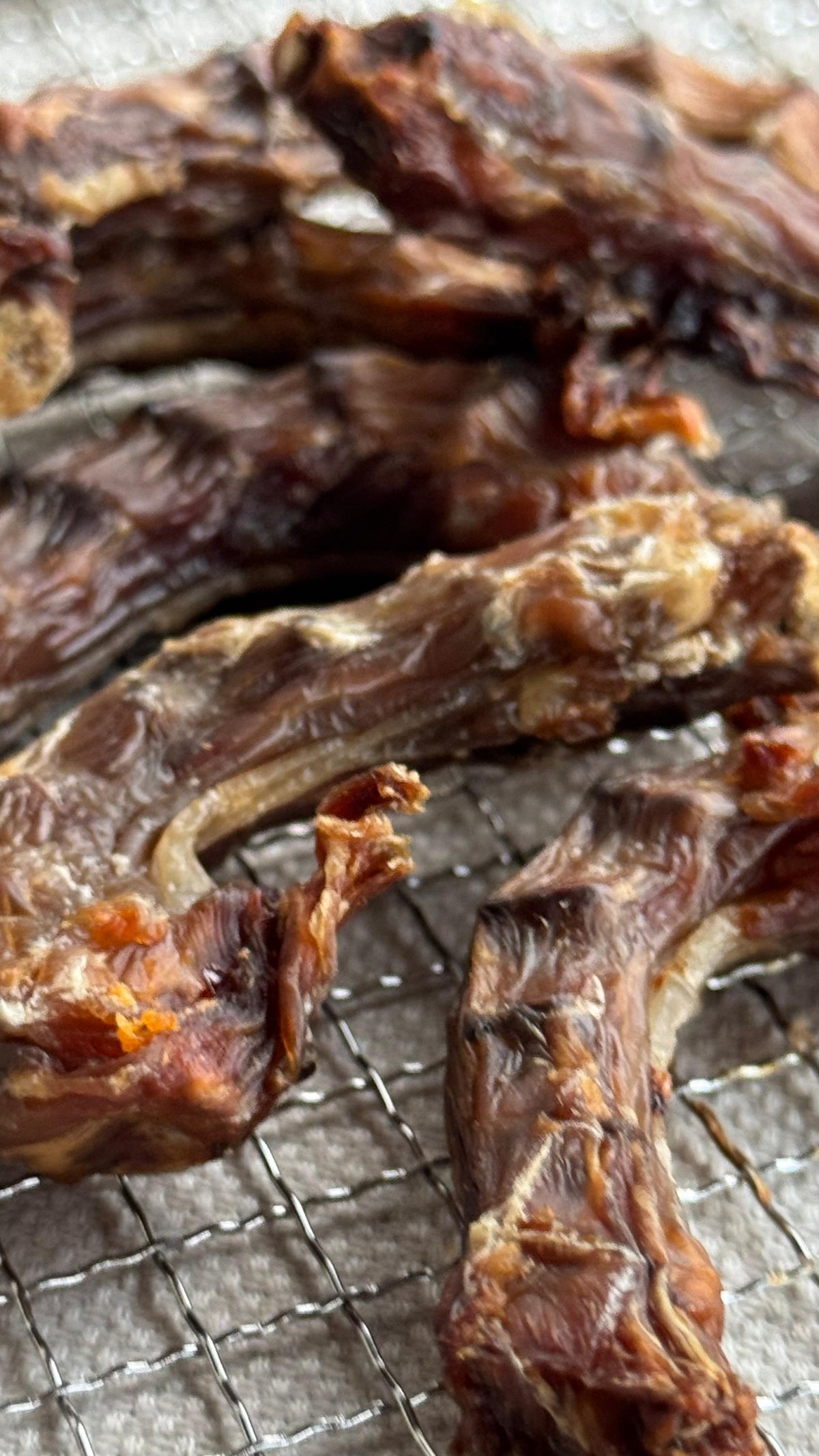 Close-up of dehydrated chicken necks showing the natural meat and cartilage texture
